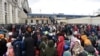 People wait for a train to Poland at the railway station of the western Ukrainian city of Lviv, March 6, 2022, 11 days after Russia launched a military invasion on Ukraine. 