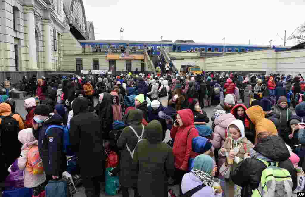 People wait for a train to Poland at the railway station of the western Ukrainian city of Lviv, March 6, 2022, 11 days after Russia launched a military operation on Ukraine.