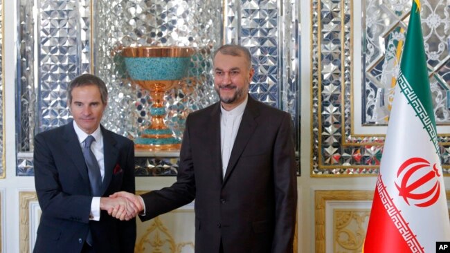 International Atomic Energy Organization, IAEA, Director General Rafael Mariano Grossi, left, and Iran's Foreign Minister Hossein Amirabdollahian shake hands prior to their meeting in Tehran, March 5, 2022.