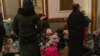 Women and children wait at the Lviv train station to get out of the country and flee the war. Lviv, March 3, 2002 (VOA/Yan Boechat) 