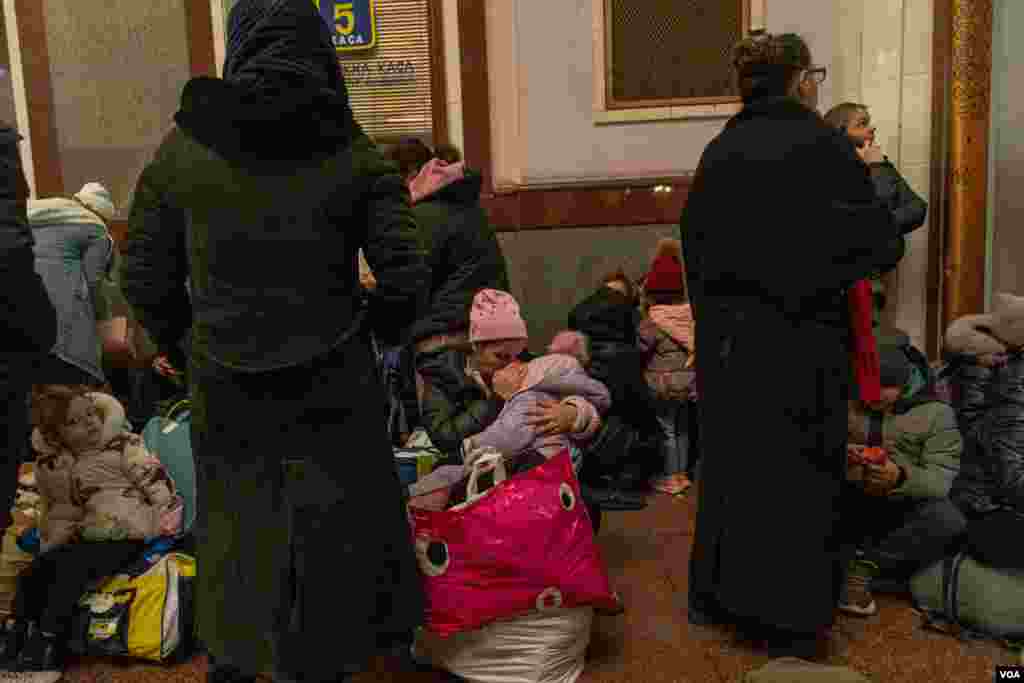 Women and children wait at the Lviv train station to get out of the country and flee the war, March 3, 2022. (VOA/Yan Boechat)