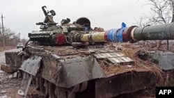 This screen grab from a handout video released by the Russian Defense Ministry on March 4, 2022, shows a destroyed Ukrainian army tank in the settlement of Gnutovo outside Mariupol.