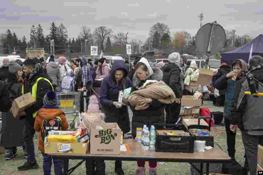 Refugees look for baby food after they arrived at the border crossing in Medyka, Poland, March 6, 2022.