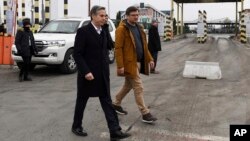 U.S. Secretary of State Antony Blinken, left, and Ukrainian Foreign Minister Dmytro Kuleba walk together after meeting at the Ukrainian-Polish border crossing in Korczowa, Poland, March 5, 2022. 