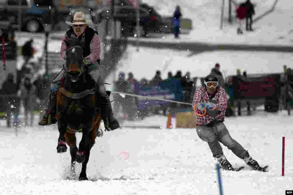 Rider Jeff Dahl (L) races down Harrison Avenue as skier and son Jason navigates the course during the 74th annual Leadville Ski Joring weekend competition, March 5, 2022 in Leadville, Colorado.