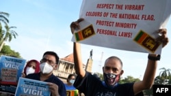 FILE - Muslim men hold placards as they take part in a demonstration demanding more rights for ethnic and religious minorities, outside Independence Square in Colombo, Sri Lanka, March 5, 2022.