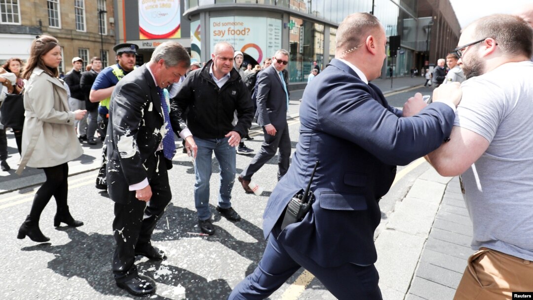 Brexit Party leader Nigel gestures after being hit with a milkshake while arriving for a Brexit Party campaign event in Newcastle, Britain, May 20, 2019. 