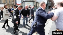 Brexit Party leader Nigel gestures after being hit with a milkshake while arriving for a Brexit Party campaign event in Newcastle, Britain, May 20, 2019. 