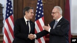 U.S. Secretary of State Antony Blinken, left, shakes hands with Latvia's President Egils Levits, ahead of their meeting, at Riga Castle in Riga, Latvia, March 7, 2022.