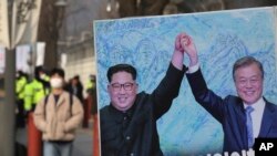 FILE - In this Jan. 15, 2019, file photo, a banner showing a photo of North Korean leader Kim Jong Un and South Korean President Moon Jae-in, right, is displayed to wish for peace on the Korean Peninsula, in Seoul, South Korea. (AP Photo/Ahn Young-joon/File)