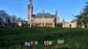 Candles are set in the grass with the text 'Putin Come Out' in front of the International Criminal Court in The Hague, Netherlands, Monday, March 7, 2022.