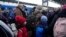 FILE - Parents accompany children and teenagers as they board a train after leaving Kyiv's Central Children's Hospital, following its evacuation, in Kyiv, Ukraine, Monday, March 7, 2022.