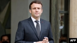 French President Emmanuel Macron stands at the Elysee Palace in Paris, on Feb. 14, 2022.