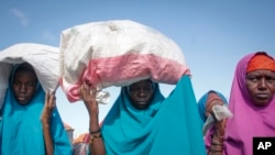 FILE - Somalis who fled drought-stricken areas arrive at a makeshift camp on the outskirts of the capital Mogadishu, Somalia, Feb. 4, 2022.