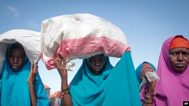 FILE - Somalis who fled drought-stricken areas arrive at a makeshift camp on the outskirts of the capital Mogadishu, Somalia, Feb. 4, 2022.