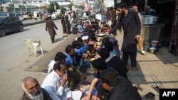 FILE - A volunteer serves food to people in need along a street in Karachi, Pakistan, on Jan. 10, 2022. Pakistan announced on Jan. 15, 2025, that the World Bank has agreed to lend $20 billion to the cash-strapped nation over 10 years.