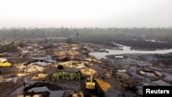 FILE: View shows an oil stained polluted mangrove in Bakana ii, Okrika local government area, Rivers state, Nigeria. 1.28.2022 