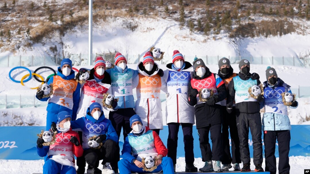 Medalists from Norway, France and the Russian Olympic Committee pose during the flower ceremony after the men's 4x7.5-kilometer relay at the 2022 Winter Olympics, Feb. 15, 2022, in Zhangjiakou, China.