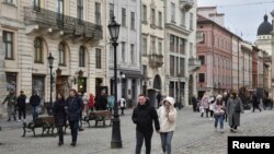 People walk along a street in central Lviv, Ukraine, Feb. 15, 2022.