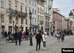 FILE - People walk along a street in central Lviv, Ukraine, Feb. 15, 2022.