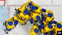 Team Sweden players celebrate after beating Canada in a men's quarterfinal hockey game at the 2022 Winter Olympics, Feb. 16, 2022, in Beijing.