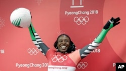 FILE - Simidele Adeagbo of Nigeria reacts in the finish area after the final run of the women's skeleton competition at the 2018 Winter Olympics in Pyeongchang, South Korea, Feb. 17, 2018.