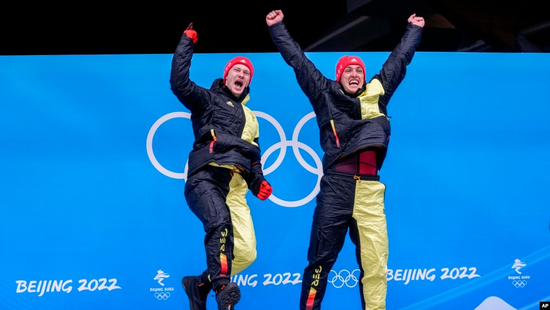 Francesco Friedrich and Thorsten Margis, of Germany, celebrate winning the gold medal in the 2-man at the 2022 Winter Olympics, Feb. 15, 2022.