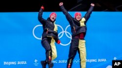 Francesco Friedrich and Thorsten Margis, of Germany, celebrate winning the gold medal in the 2-man at the 2022 Winter Olympics, Feb. 15, 2022.