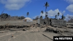 FILE - A general view shows damaged buildings and landscape covered with ash following the volcanic eruption and tsunami in Kanokupolu, Tonga, Jan. 23,2022. (Tonga Red Cross Society/Handout via Reuters)