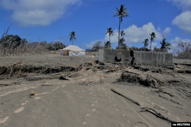 FILE - A general view shows damaged buildings and landscape covered with ash following the volcanic eruption and tsunami in Kanokupolu, Tonga, Jan. 23,2022. (Tonga Red Cross Society/Handout via Reuters)