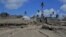 FILE - A general view shows damaged buildings and landscape covered with ash following the volcanic eruption and tsunami in Kanokupolu, Tonga, Jan. 23,2022. (Tonga Red Cross Society/Handout via Reuters)