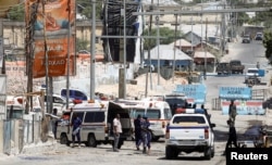 FILE - Somali security forces secure the road leading to the scene of an explosion at a checkpoint near the Presidential palace in Mogadishu, Feb. 10, 2022.