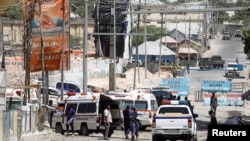 FILE - On Feb. 10,2022, Somali security forces secure the road leading to the scene of an explosion at a checkpoint near the presidential palace in Mogadishu, Somalia. A roadside bomb injured four people in the city on March 17, 2022.