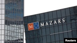FILE - The logo of Mazars is seen on a building in the financial district of la Defense near Paris, France, May 14, 2018. 