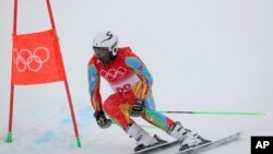 Shannon-Ogbnai Abeda, of Eritrea passes a gate during the first run of the men's giant slalom at the 2022 Winter Olympics, Feb. 13, 2022, in the Yanqing district of Beijing. 