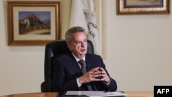 FILE - Lebanon's Central Bank Governor Riad Salameh gives an interview with AFP at his office in the capital Beirut, Dec. 20, 2021.