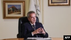 FILE - Lebanon's Central Bank Governor Riad Salameh gives an interview with AFP at his office in the capital Beirut, Dec. 20, 2021.