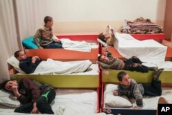 Internally displaced children from Mariupol prepare to sleep in a kindergarten in Zaporizhia, Ukraine, March 21, 2022.