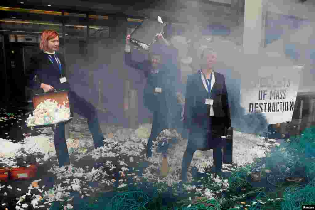 Ocean Rebellion activists stage a protest with items representing plastic nurdles, outside the International Maritime Organization in London. ( REUTERS/Peter Nicholls)