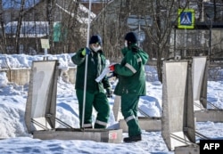 FILE - BP petrol station employees check fuel tanks in the town of Chekhov outside Moscow, March 9, 2022.