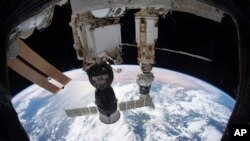 FILE: This photo provided by NASA shows the International Space Station orbited 424km above the Tyrrhenian Sea with the Soyuz MS-19 crew ship docked to the Rassvet module and the Prichal module. Taken 2.23.2022