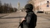 A Ukrainian serviceman stands at a checkpoint in Kyiv, Ukraine, March 24, 2022. Ukraine President Volodymr Zelenskyy called on people worldwide to gather in public Thursday to show support for his embattled country.