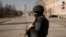 A Ukrainian serviceman stands at a checkpoint in Kyiv, Ukraine, March 24, 2022. Ukraine President Volodymr Zelenskyy called on people worldwide to gather in public Thursday to show support for his embattled country.