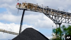 FILE - Coal is dumped onto a stack at a mine near in Muswellbrook in the Hunter Valley, Australia, Nov. 2, 2021. 