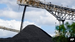 FILE - Coal is dumped onto a stack at a mine near in Muswellbrook in the Hunter Valley, Australia, Nov. 2, 2021. 