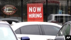 FILE - A hiring sign is displayed at a restaurant in Buffalo Grove, Illinois, March 19, 2022.