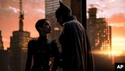 Image released by Warner Bros. Pictures shows Zoe Kravitz, left, and Robert Pattinson in a scene from "The Batman." Pattinson’s debut as the Dark Knight earned an additional $36.8 million over the weekend, according to studio estimates March 20, 2022.