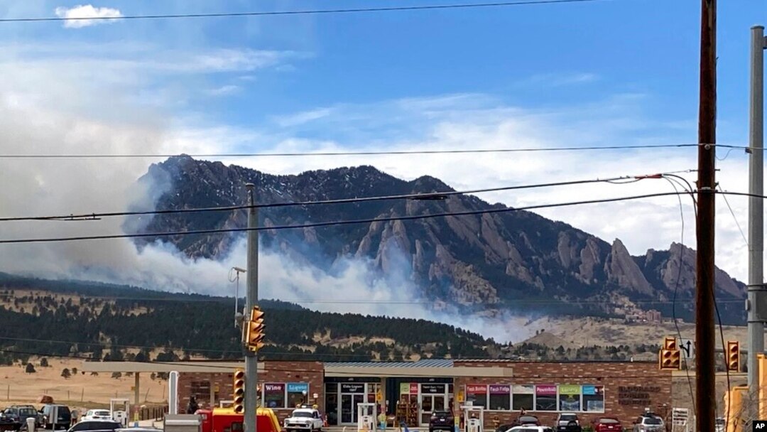 Smoke billows from a wildfire March 26, 2022 in Marshall, Colo. a few miles south of Boulder, Colo. 