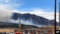 Smoke billows from a wildfire March 26, 2022 in Marshall, Colo. a few miles south of Boulder, Colo. 