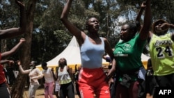 A group of women's right campaigner take part in celebrations for International Women's Day with residents of informal settlement in Nairobi on March 8, 2022.